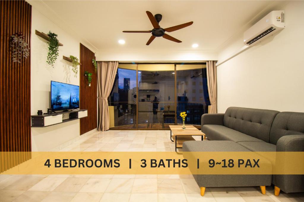 a living room with a couch and a ceiling fan at Downtown Condo KL City - 18 pax in Kuala Lumpur