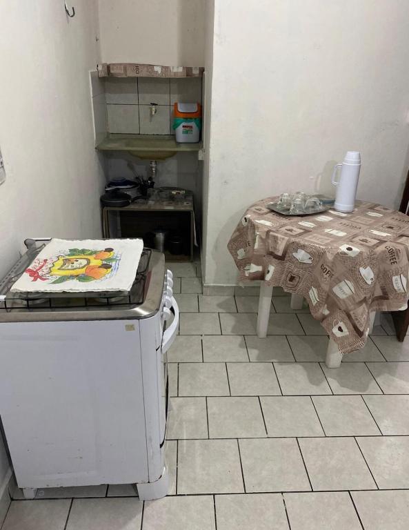 a kitchen with a table and a small table with a table at kitnet bem localizado in João Pessoa