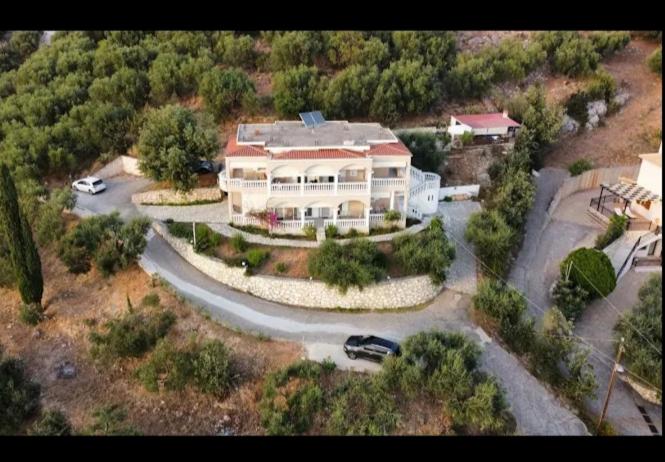 an aerial view of a large house with a driveway at Charoula's Apartments in Syvota