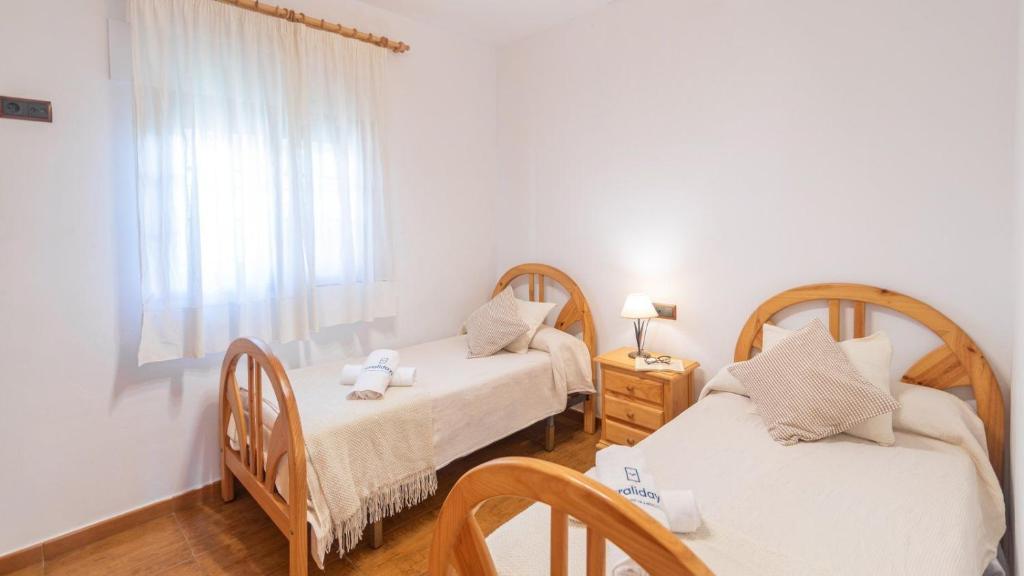Postel nebo postele na pokoji v ubytování Cortijo La Encina Sayalonga by Ruralidays