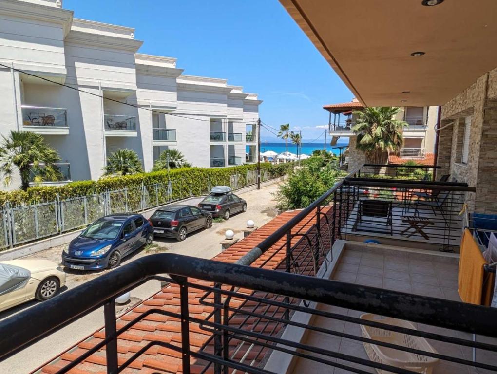 a balcony with cars parked in a parking lot at Sea House in Hanioti