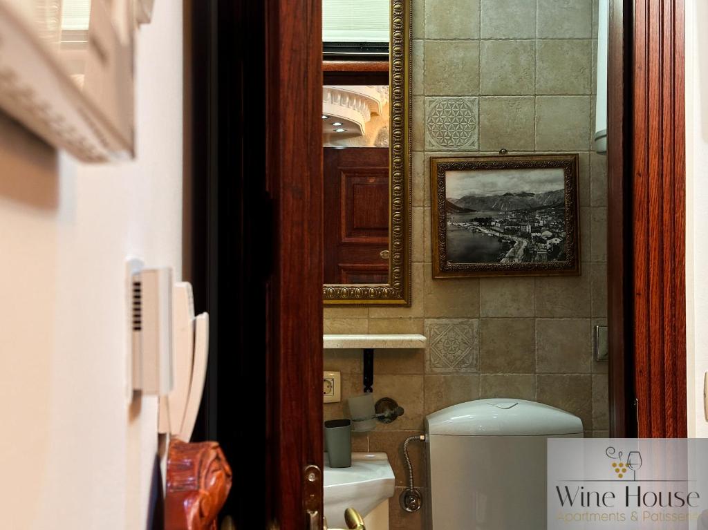 a bathroom with a mirror and a white toilet at Apartments Wine House Old Town in Kotor