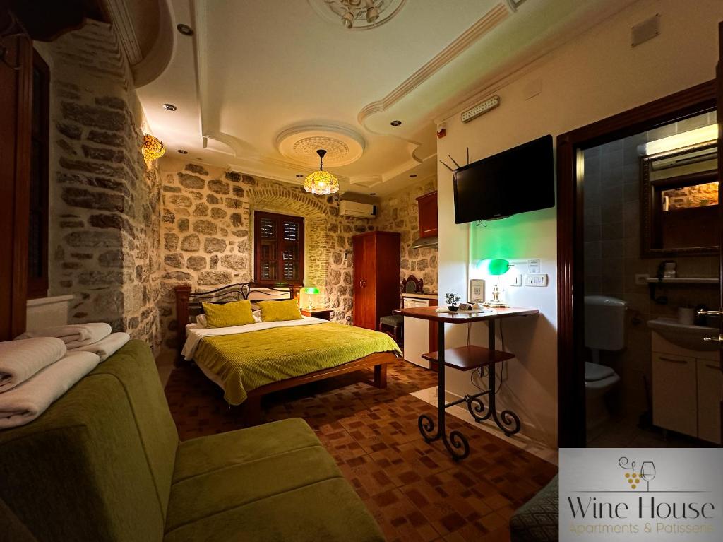 a bedroom with a bed and a room with a wine house at Apartments Wine House Old Town in Kotor