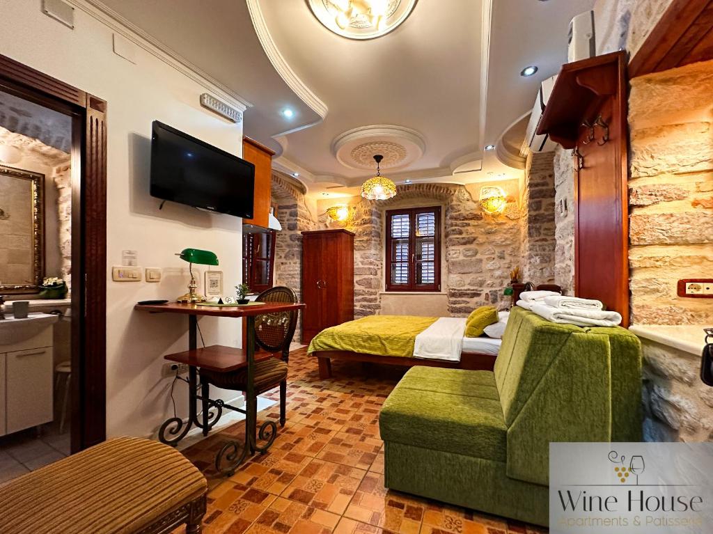 a hotel room with a bed and a living room at Apartments Wine House Old Town in Kotor