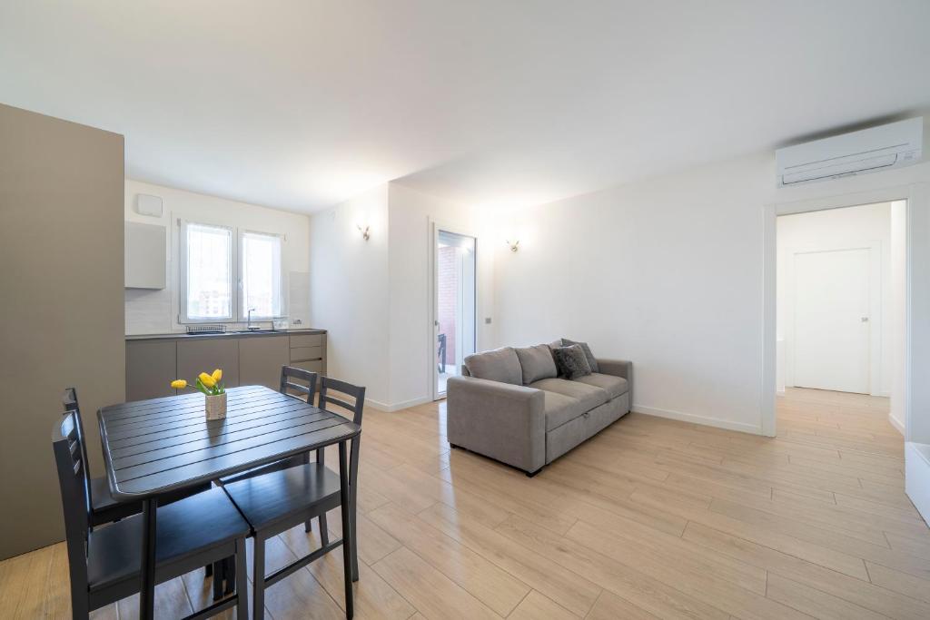 un soggiorno con un tavolo e un divano di Parco Comfort Suite Battaglia Appartamenti a Milano