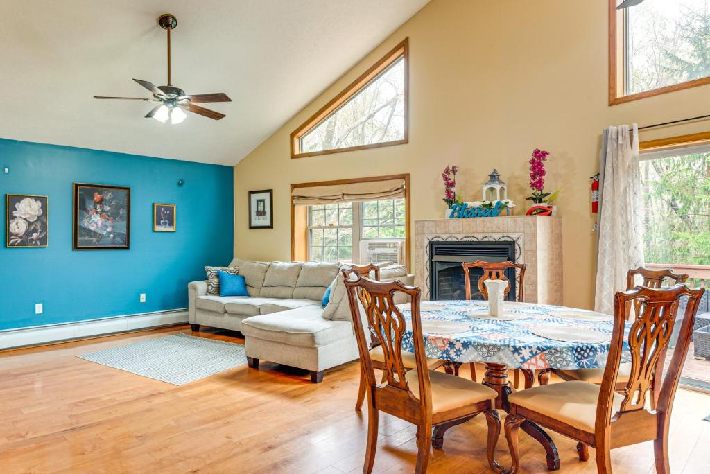 a living room with a table and a couch at Resort Amenities and Game Room Arrowhead Lake Home! in Pocono Lake