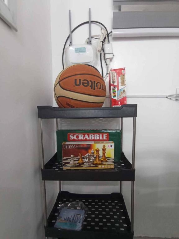 a shelf with a basketball and a ball on it at EC Tamayo House Rental in Bangad