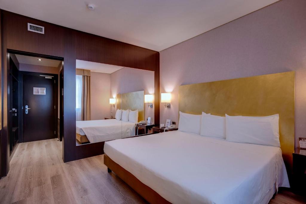 Postel nebo postele na pokoji v ubytování Hotel Nord