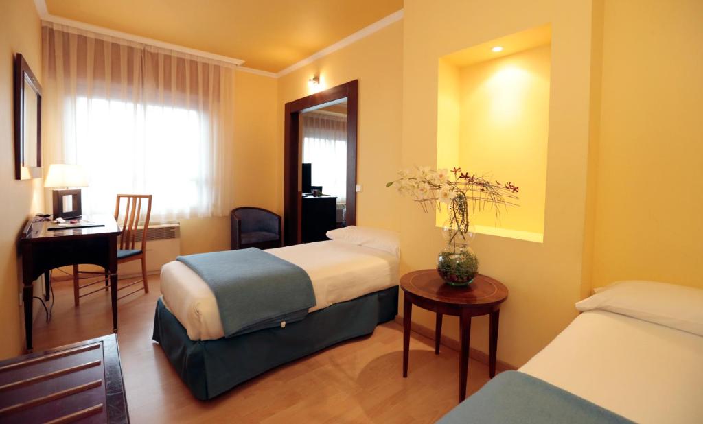 Postel nebo postele na pokoji v ubytování Hotel Spa Congreso