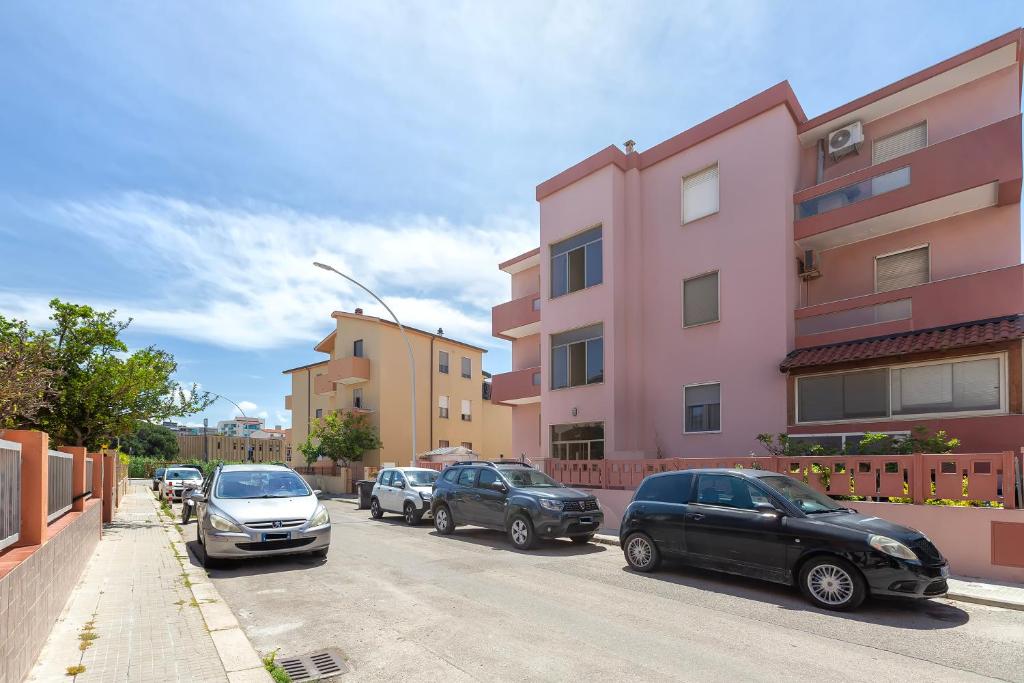 a group of cars parked on the side of a street at Favola Rosa in Alghero