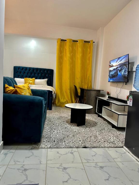 a living room with a couch and a table at Gee Kamakis Airbnbs in Ruiru