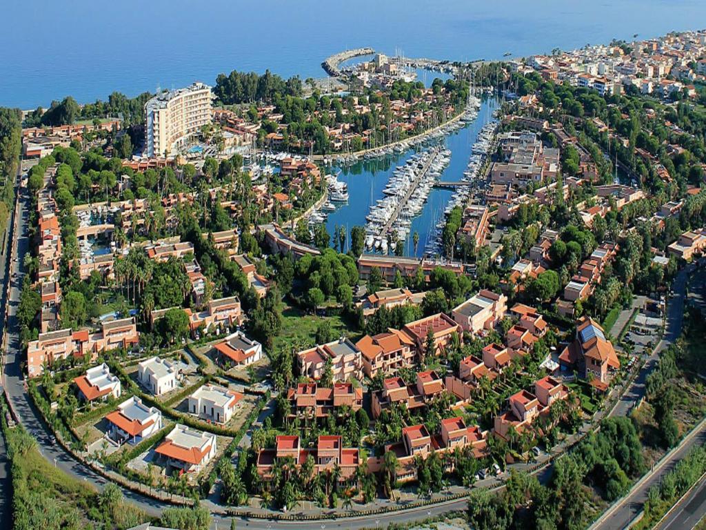 an aerial view of a city with a harbor at Baia Dei Delfini in Furnari