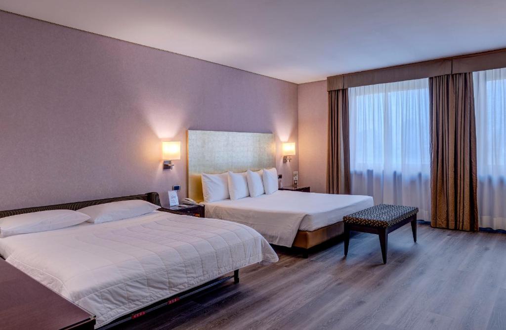 Postel nebo postele na pokoji v ubytování Hotel Nord