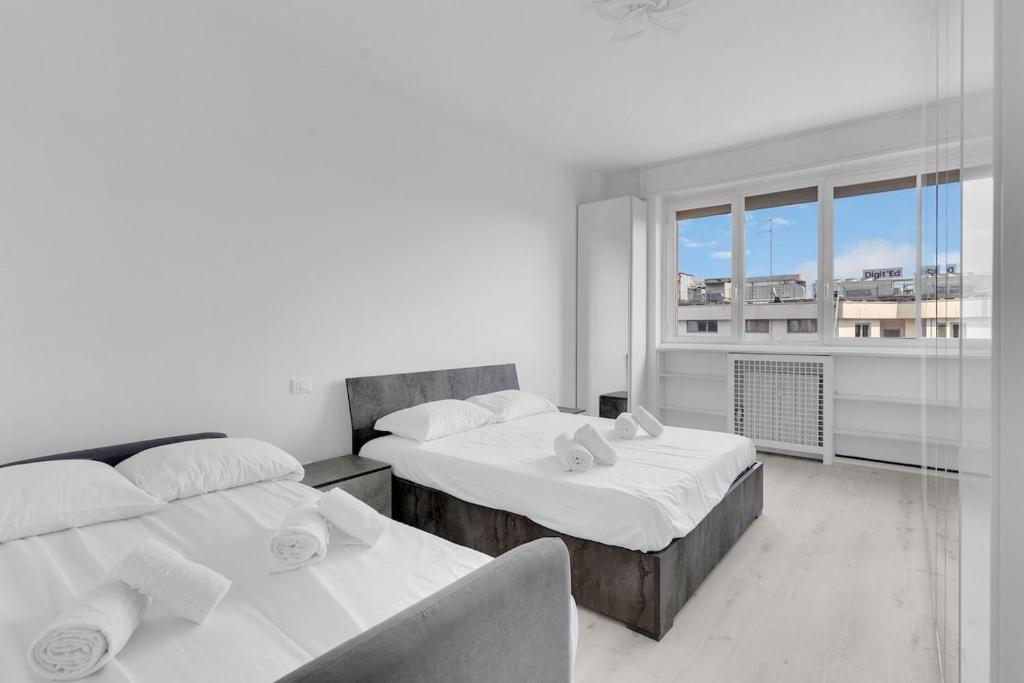 Postel nebo postele na pokoji v ubytování Metro M2 Famagosta-Appartamento x5-self check-in