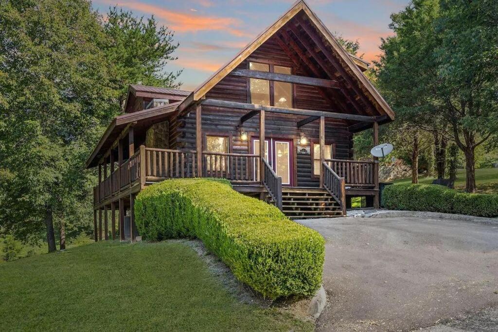 a log cabin with a large staircase in front of it at Smokies Outlook by Avada Properties in Pigeon Forge