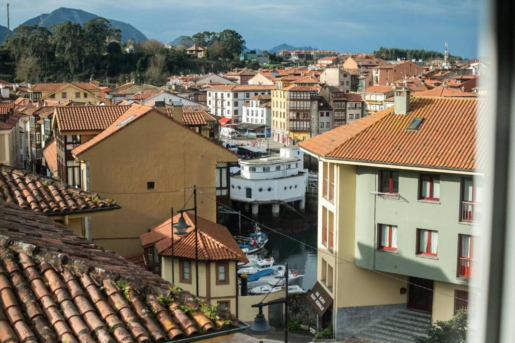 a view of a city with buildings and roofs at Durmiendo en el Paraiso in Llanes