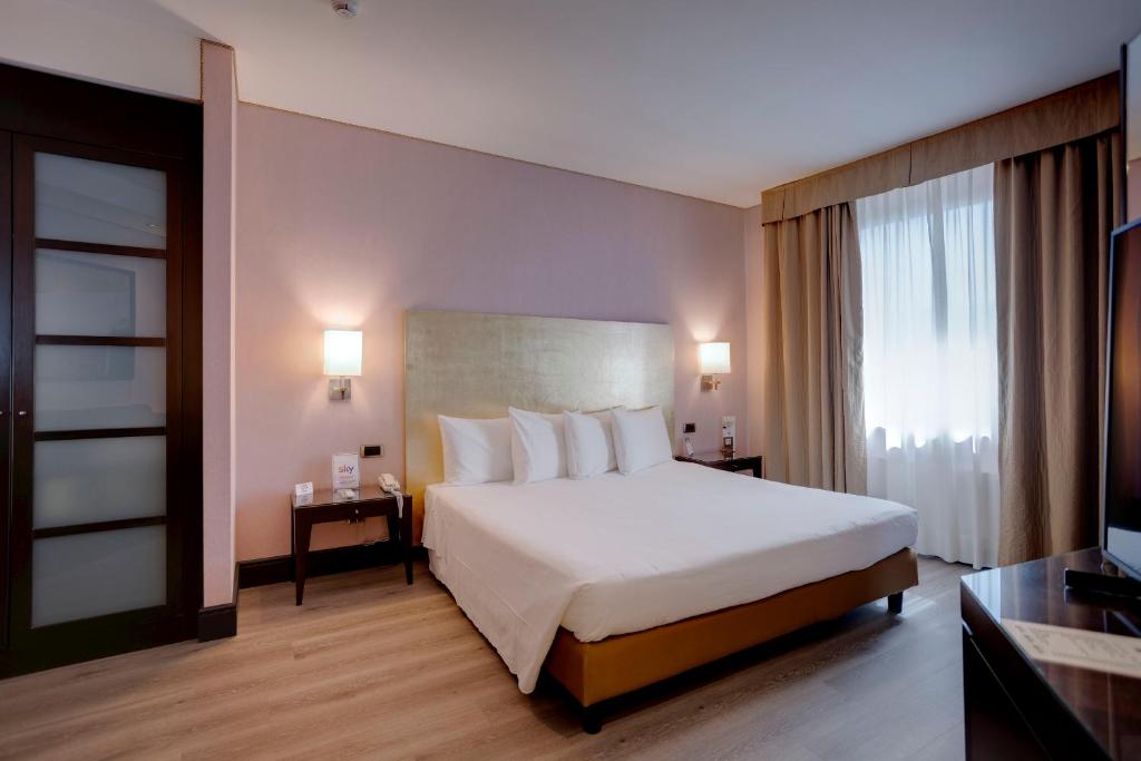 Postel nebo postele na pokoji v ubytování Hotel Nord