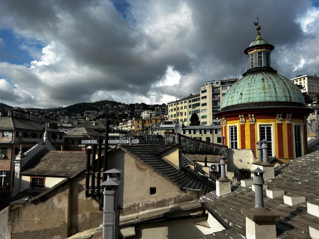 a building with a dome on top of a city at Genova Antica in Genoa