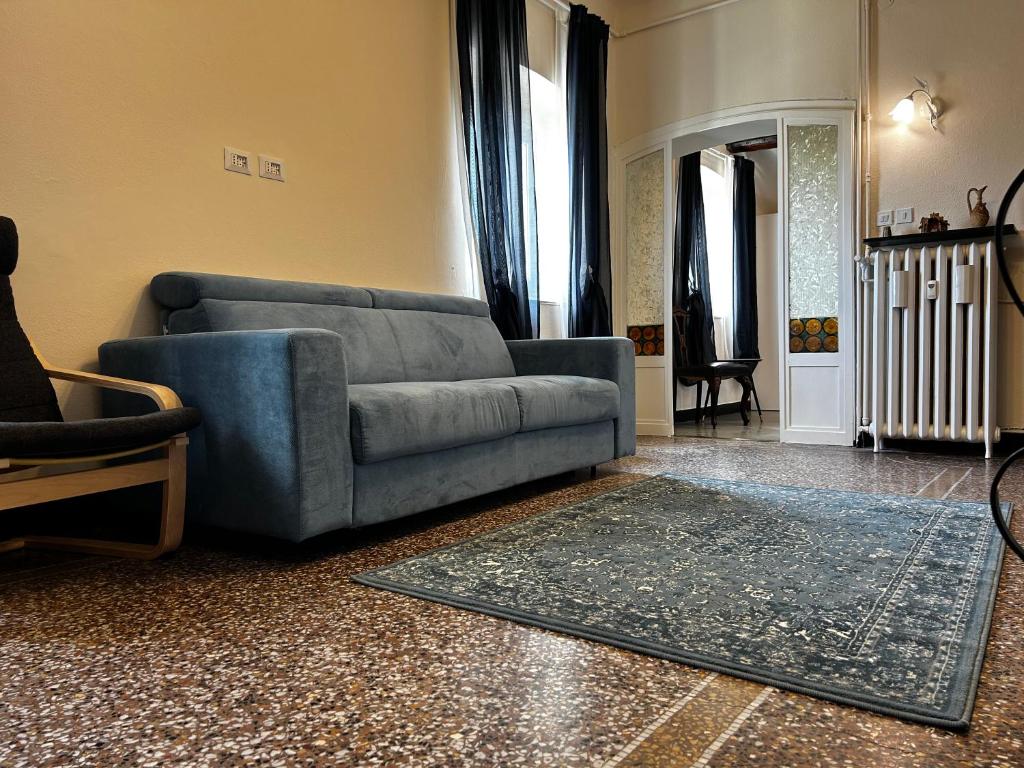 a living room with a blue couch and a rug at Genova Antica in Genoa
