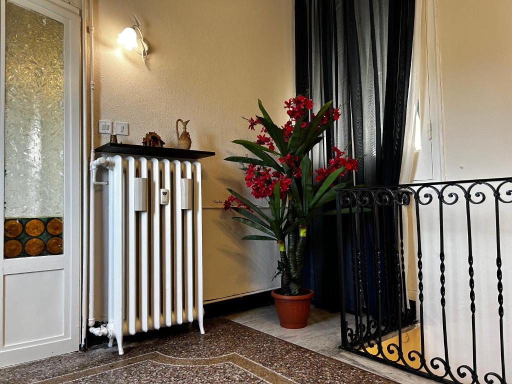 a porch with a radiator and a plant next to a door at Genova Antica in Genoa
