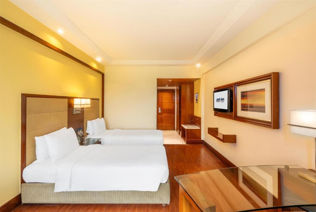 Postel nebo postele na pokoji v ubytování Park Inn Gurgaon