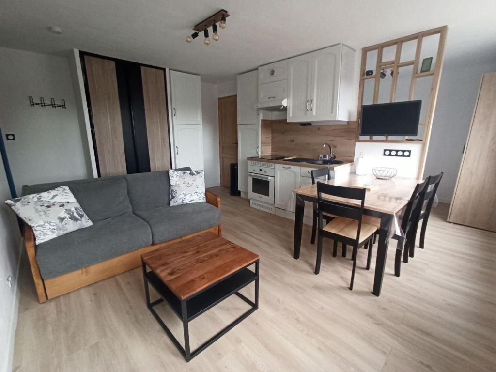 un salon et une cuisine avec un canapé et une table dans l'établissement Studio cabine 4 pers 2* avec équipements pratiques à Valloire - FR-1-263-588, à Valloire