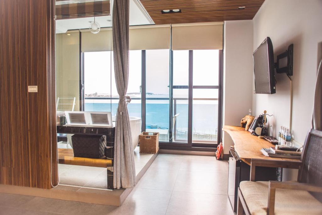 a living room with a view of the ocean at Villa Iris in Baisha