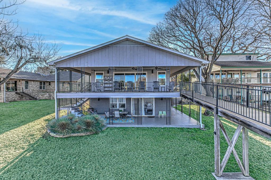 a large house with a porch and a balcony at Waterfront Family Home for 12 w Deck & Lake Views in Kingsland