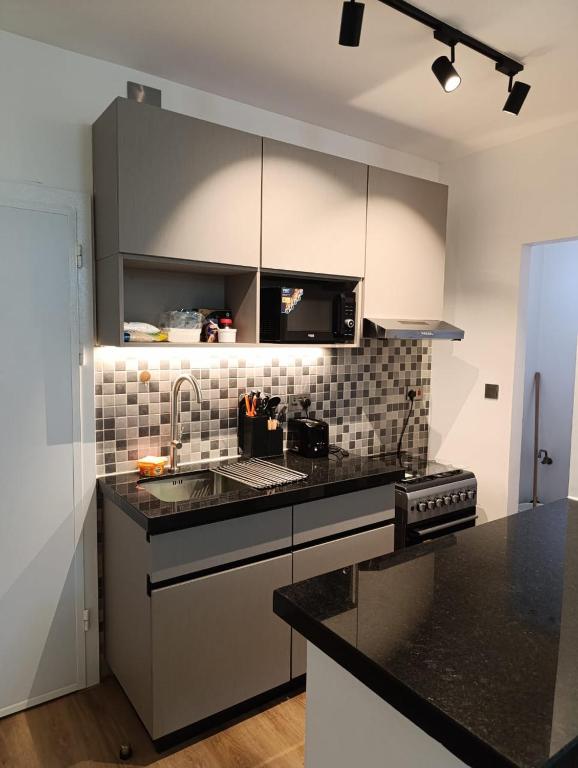 a kitchen with a sink and a stove top oven at Pleasant view in Tatu City