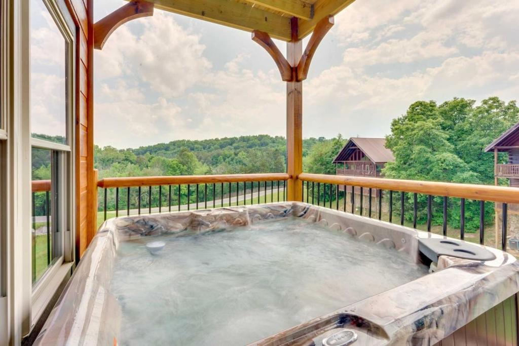 a hot tub on the balcony of a house at Misty Mountain Stop by Avada Properties in Pigeon Forge