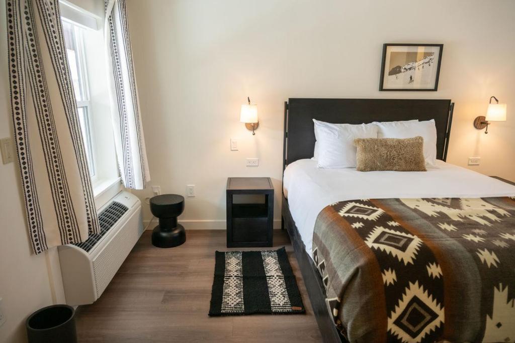 a bedroom with a bed and a window at High Creek Lodge and Cabins in Pagosa Springs
