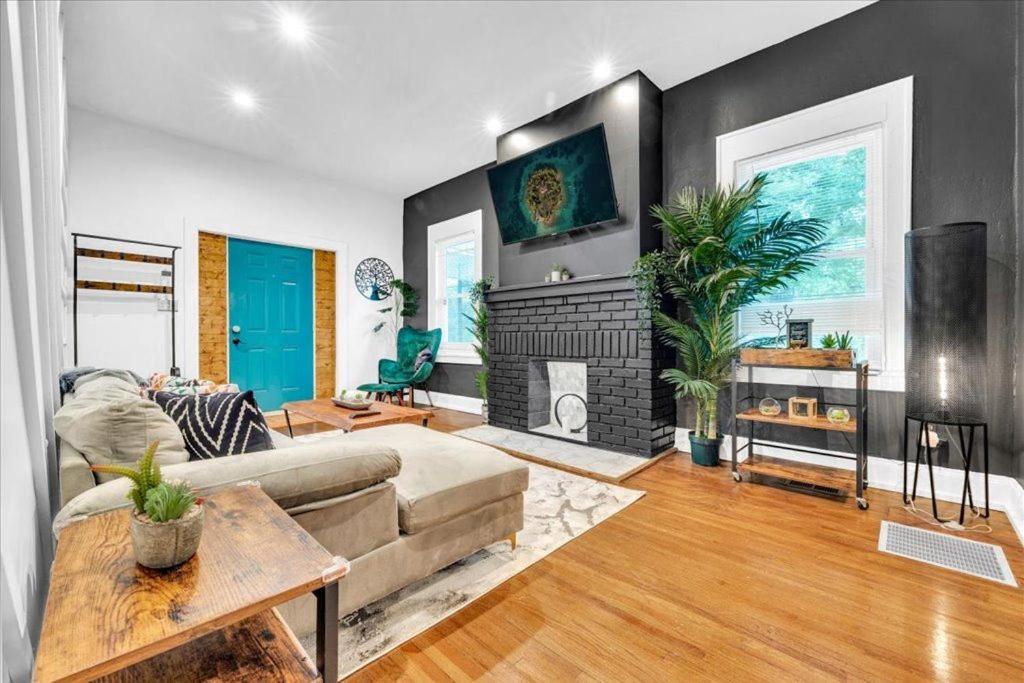 a living room with a couch and a fireplace at Serenity House 2BR Central Location in ATL in Atlanta