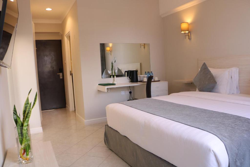 Postel nebo postele na pokoji v ubytování Maanzoni 680 HOTEL