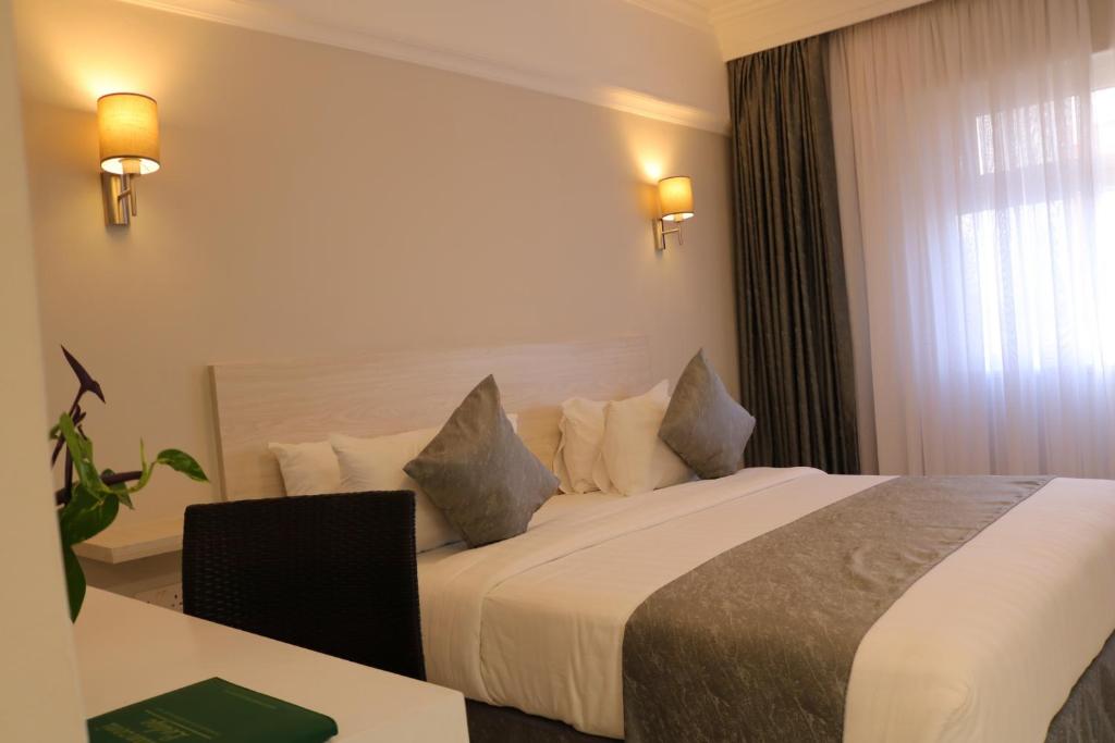 Postel nebo postele na pokoji v ubytování Maanzoni 680 HOTEL