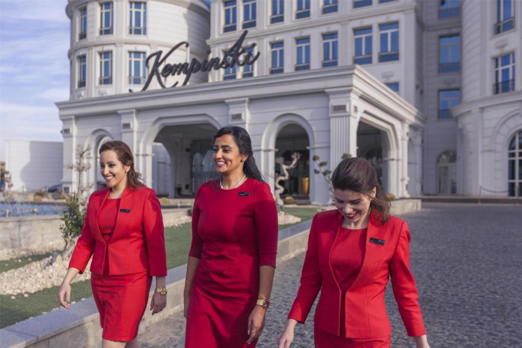 three women in reduits walking in front of a building at Royal Maxim Palace Kempinski Cairo in Cairo