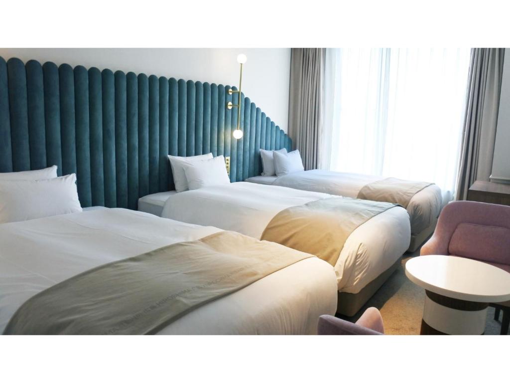 Кровать или кровати в номере THE KNOT HIROSHIMA - Vacation STAY 32490v