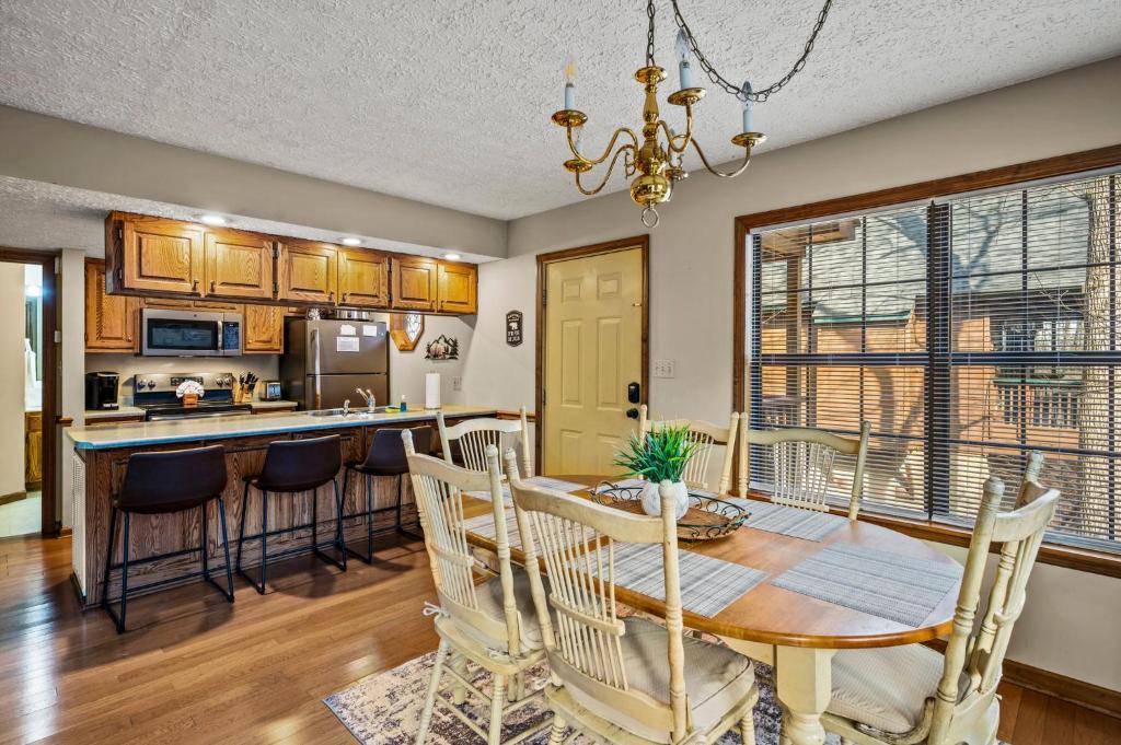 a kitchen and dining room with a table and chairs at Lazy Dayz by Avada Properties in Pigeon Forge