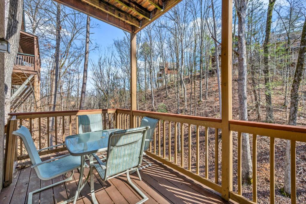a deck with two chairs and a table on it at Lazy Dayz by Avada Properties in Pigeon Forge