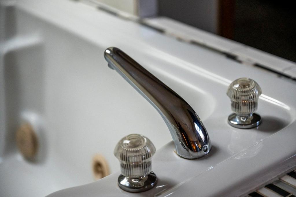 a bathroom sink with a silver faucet and two knobs at Lazy Dayz by Avada Properties in Pigeon Forge