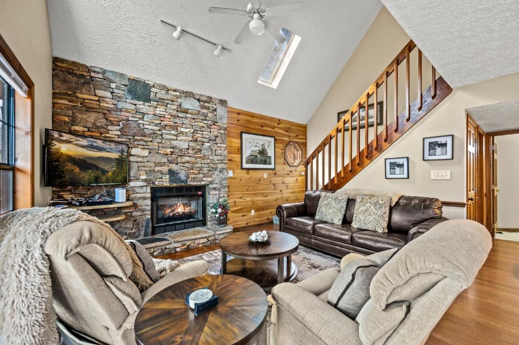 a living room with a couch and a fireplace at Lazy Dayz by Avada Properties in Pigeon Forge