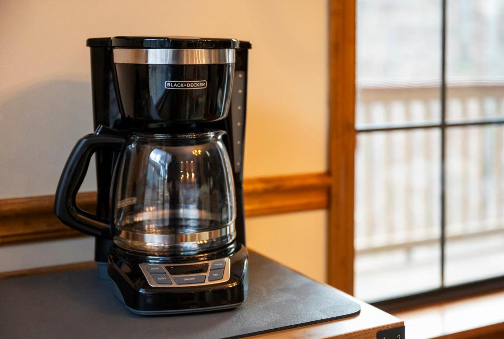 a black coffee maker sitting on top of a counter at Lazy Dayz by Avada Properties in Pigeon Forge