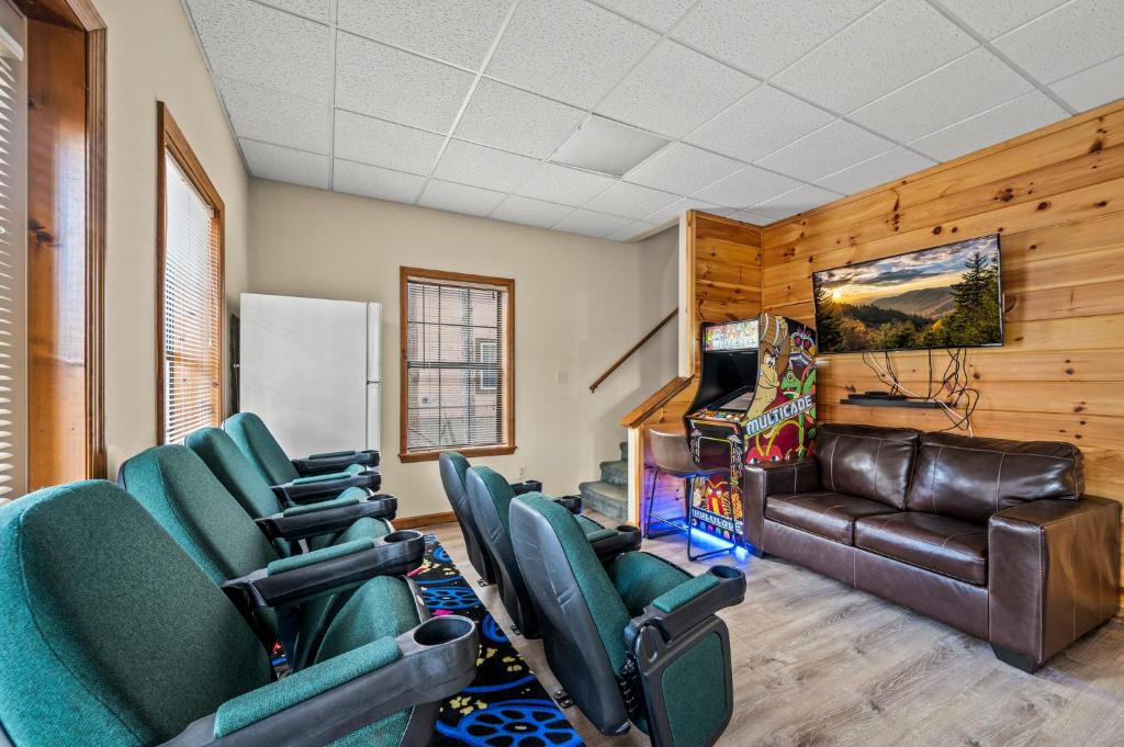 a living room with green chairs and a couch at Lazy Dayz by Avada Properties in Pigeon Forge