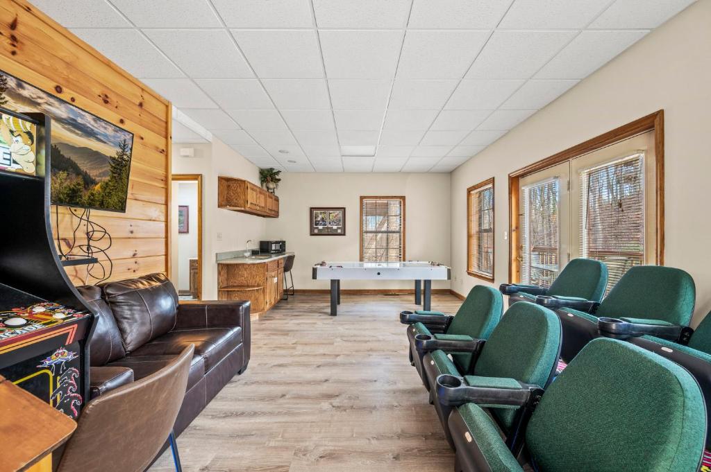 a room with a ping pong table and chairs at Lazy Dayz by Avada Properties in Pigeon Forge