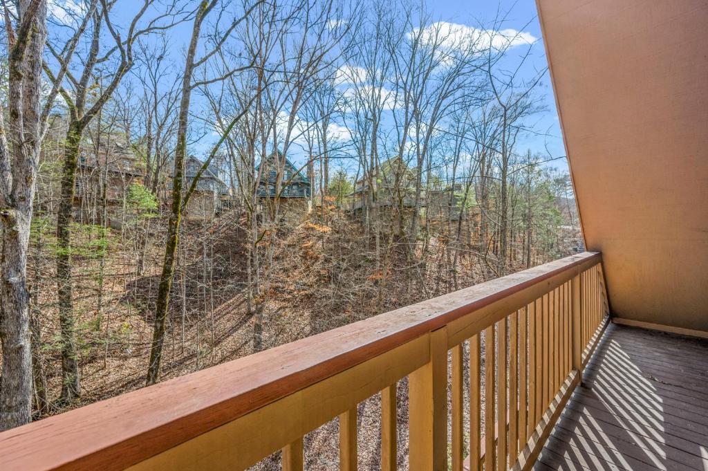 a balcony with a view of the woods at Lazy Dayz by Avada Properties in Pigeon Forge