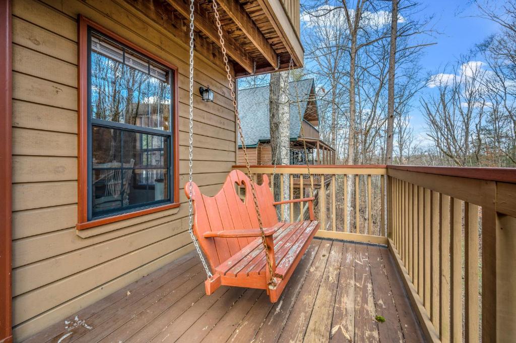 a rocking chair on the porch of a house at Lazy Dayz by Avada Properties in Pigeon Forge