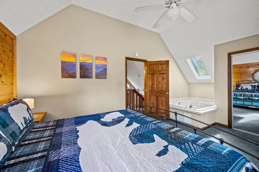 a bedroom with a large bed and a bathroom at Lazy Dayz by Avada Properties in Pigeon Forge