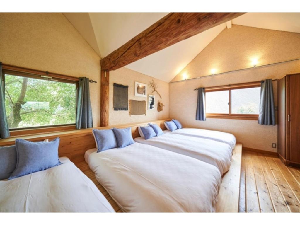 a row of four beds in a room at Fiore Shima - Vacation STAY 25657v in Shima