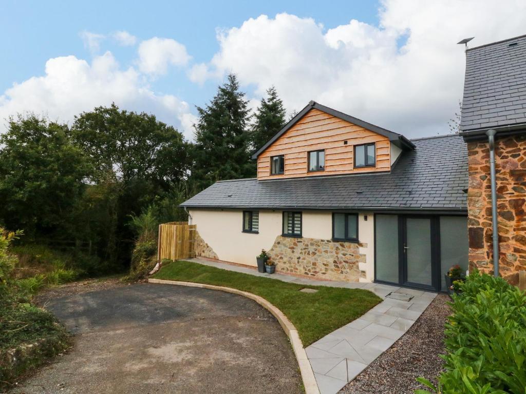 a detached house with a garage and a driveway at Spicery in Exeter