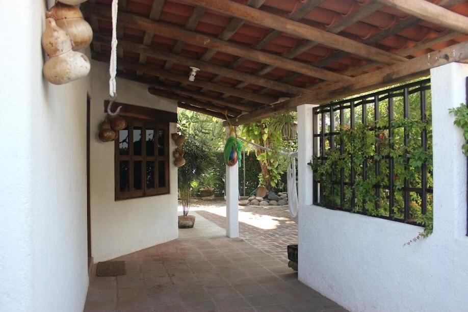 an entrance to a house with a gate with bottles at Casa Fragatas in Ixtapa in Ixtapa