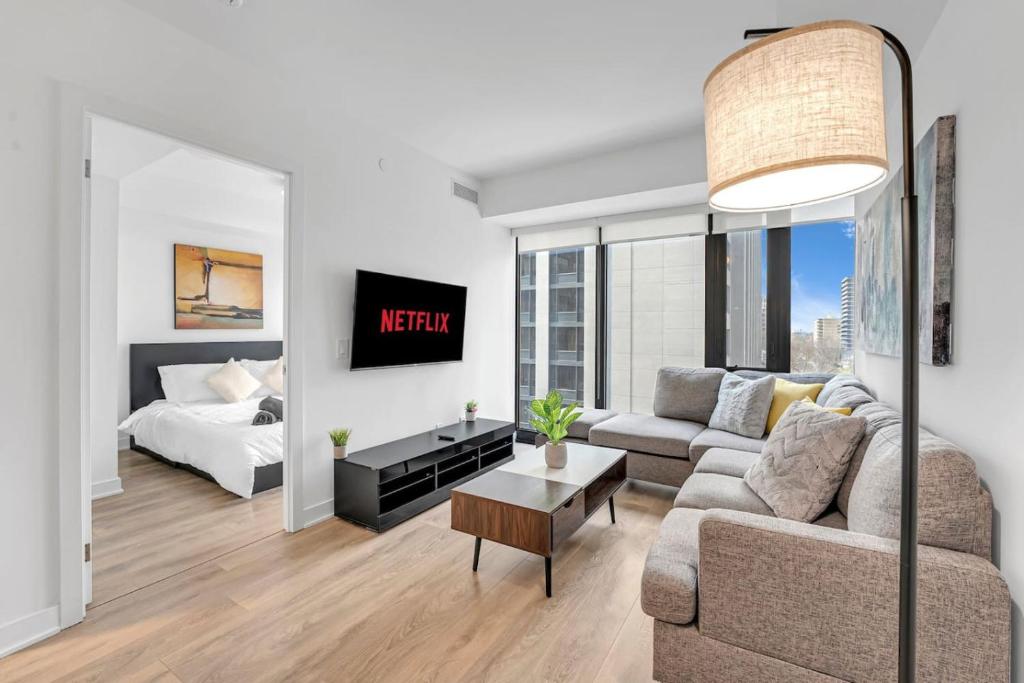 a living room with a couch and a bed at Cozy Condo Near Restaurant TTC in Toronto